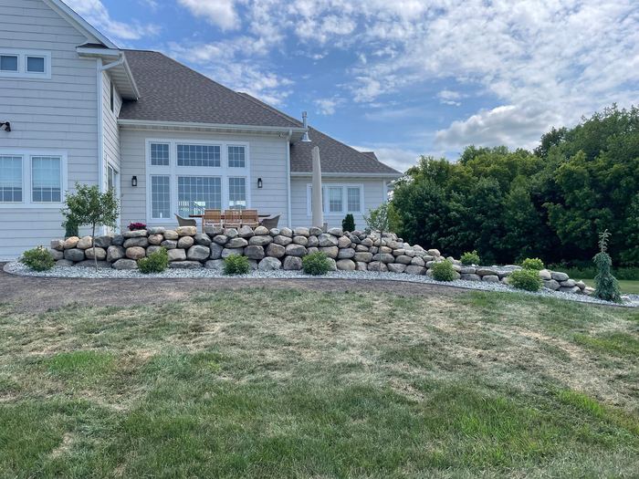 Boulder wall along a sloped front yard